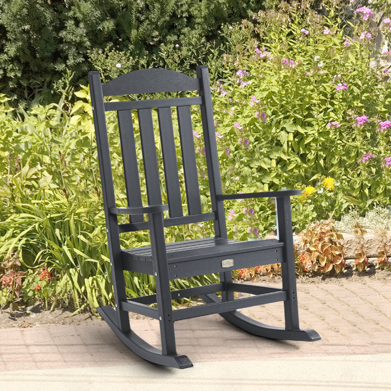 Lifestyle image of Adirondack Outdoor Rocking Chair in Black outdoors
