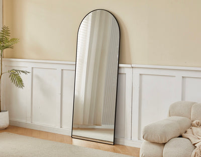 Angled view of the Selena Metal Arched Wall Mirror in black color.