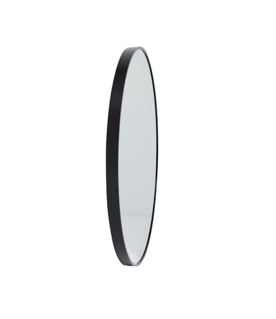 Close-up of the frame of the Stella Round Metal Framed Wall Mirror in black.